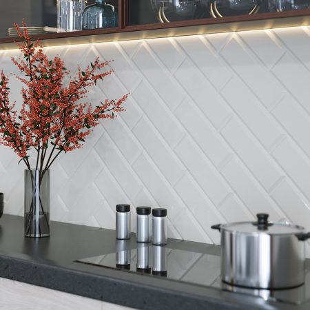 metro white beveled tiles in 10x30cm tiled on a kitchen splash back.