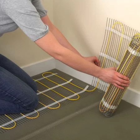 image of an installer laying electric underfloor heating mat 150w